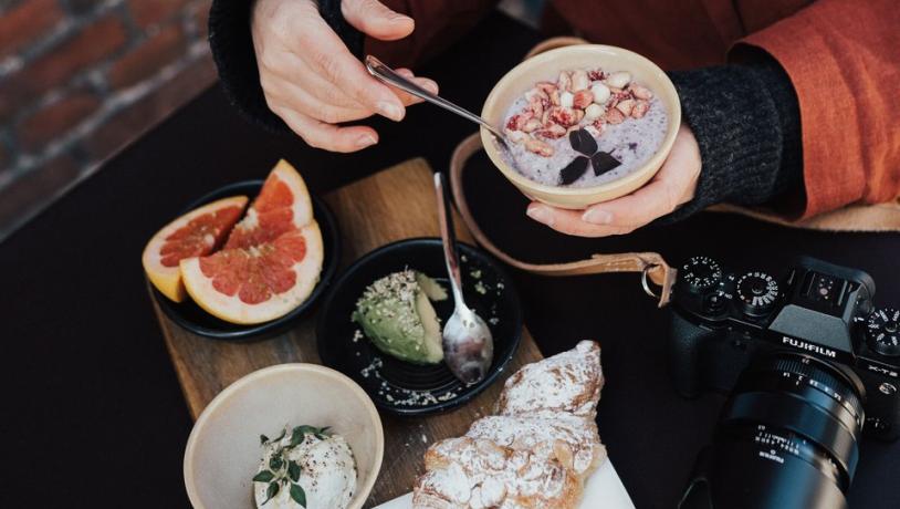 Woman having brunch outside in Copenhagen in autumn