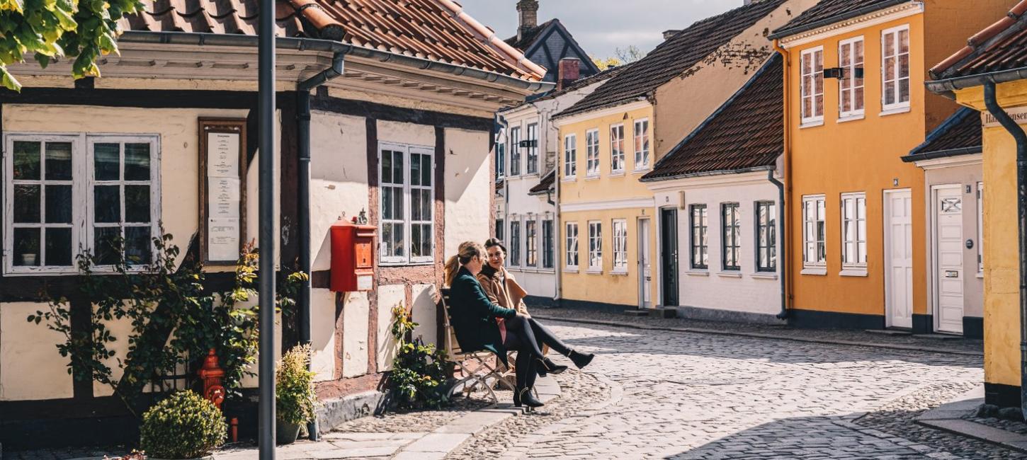 Women sitting on a bench in old town of Odense on Fyn