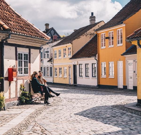 Women sitting on a bench in old town of Odense on Fyn