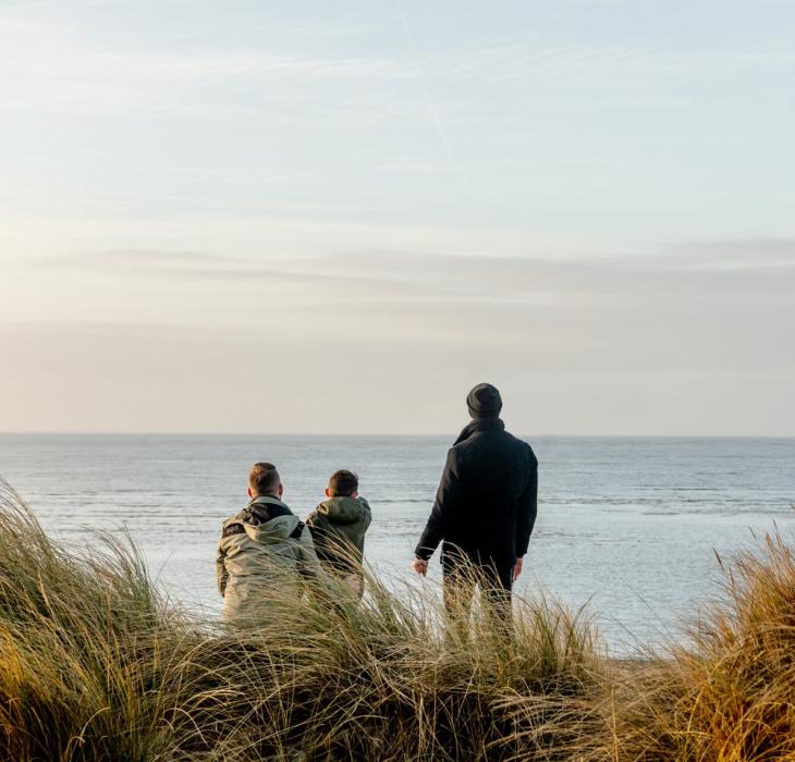 Family watching the sea on Blåvand beach in West Jutland