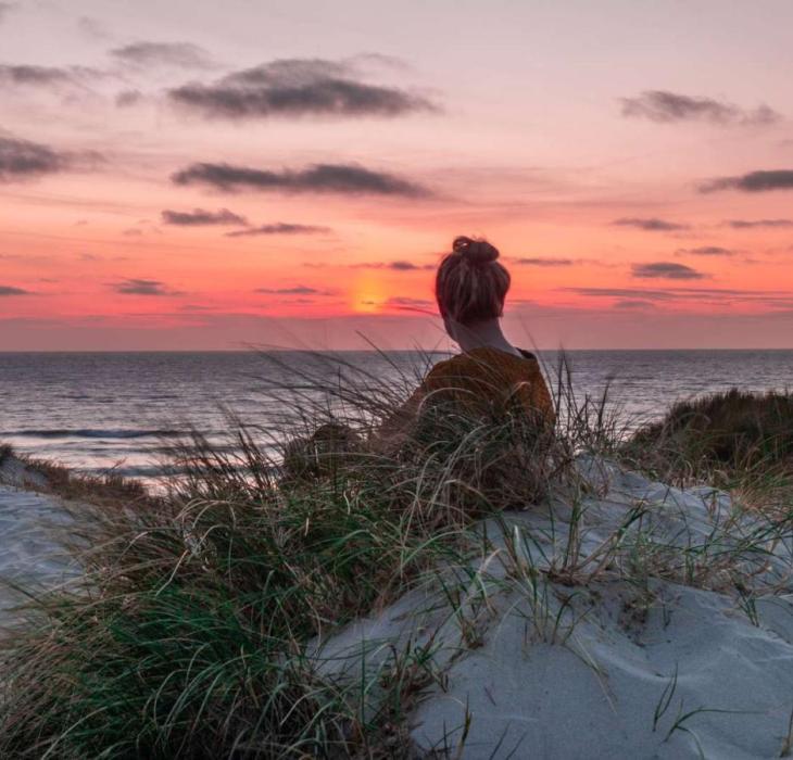 Woman watching the sunset on Søndervig beach, Vesterhavet